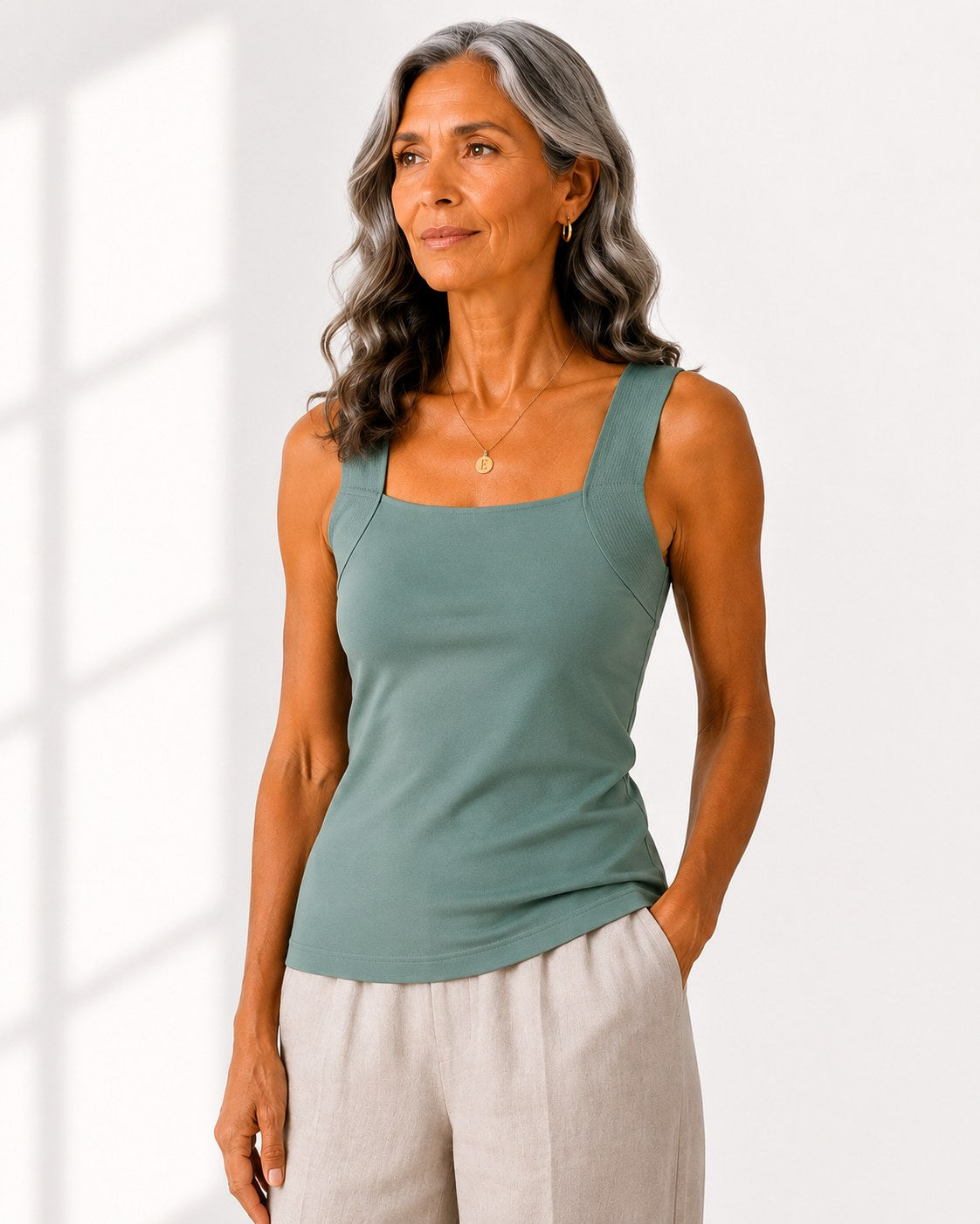 Woman wearing the Faye Built-In Support Tank in Sage