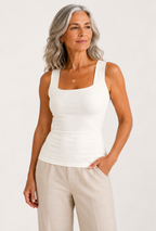 Woman wearing the Faye Built-In Support Tank in Ivory, showing the wide ribbed straps and built-in support band